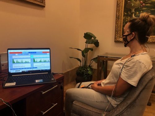 Micro Current Neurofeedback patient watches her brainwaves registering on a computer screen