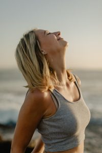 woman taking deep breath after doing breathwork therapy in la jolla