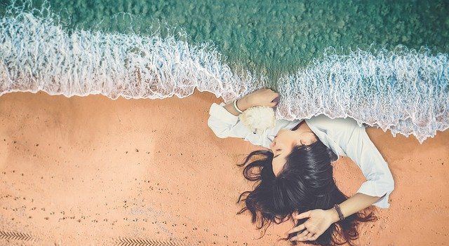 woman sleeping on beach