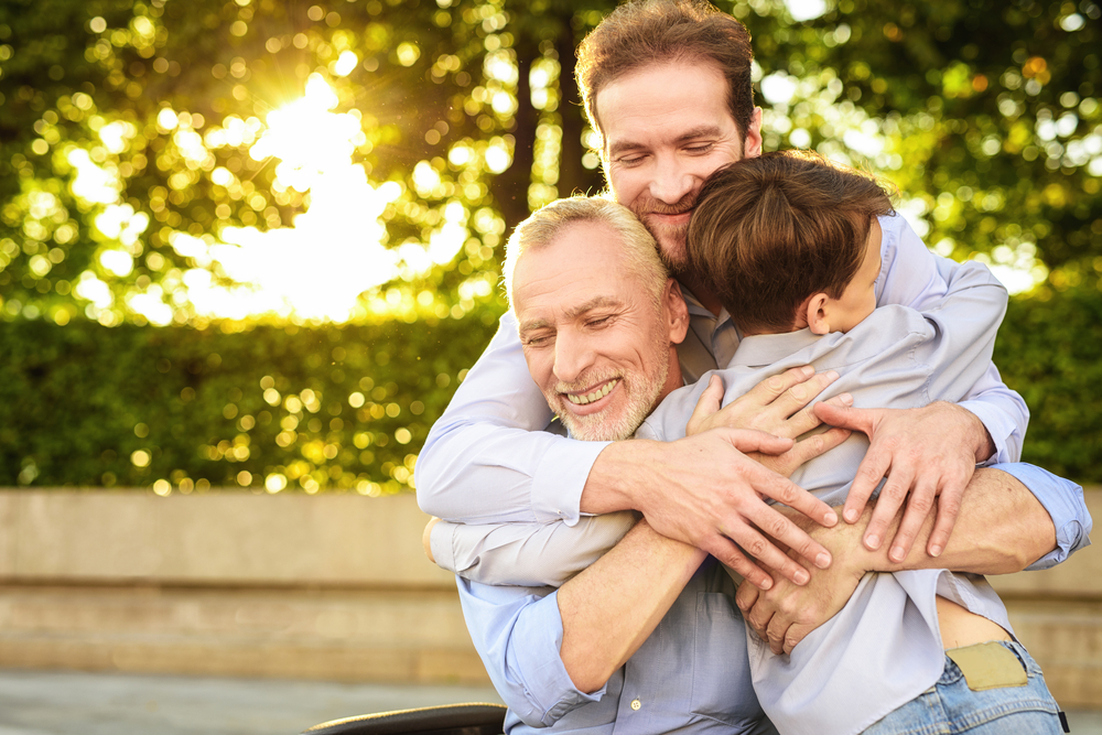 older man with family hugging